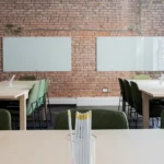 A clean office with two tables.