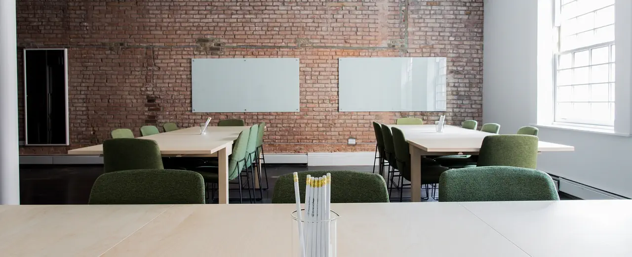 A clean office with two tables.